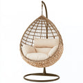 Poltrona sospesa in rattan sintetico beige con struttura in acciaio, misura 105x105x195 cm, ideale per giardino.